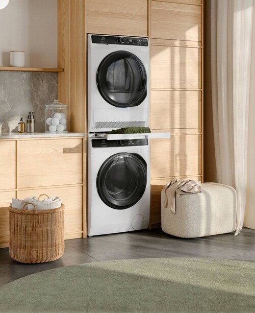 Electrolux tumble dryer and washing machine stacked on top of each other in a sunny room.